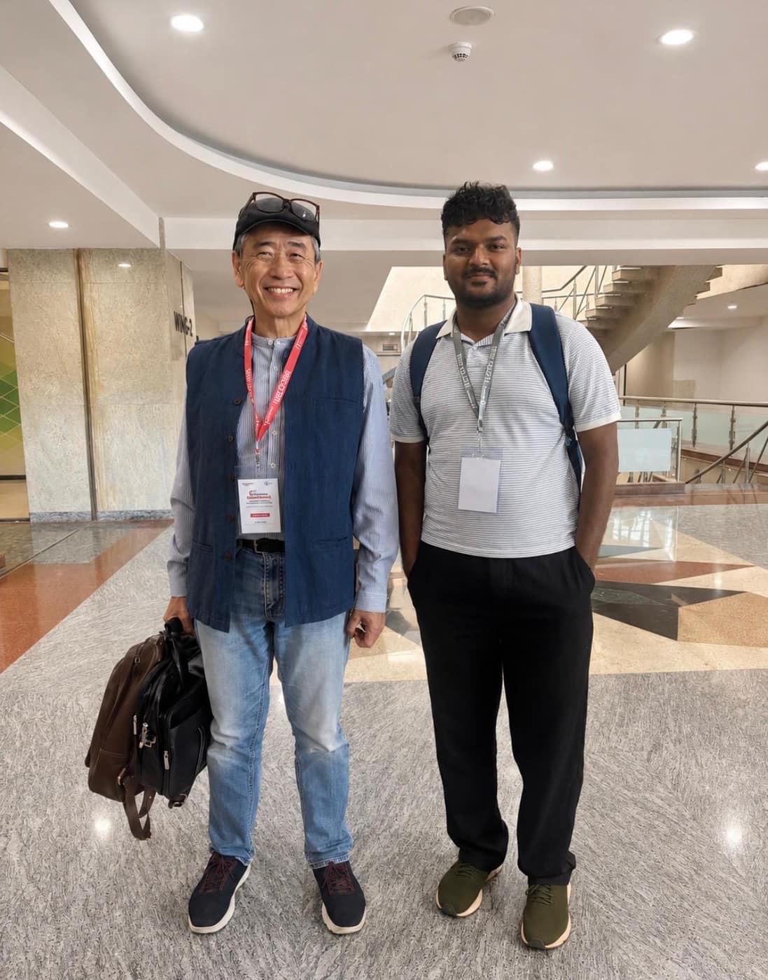 Aman Chandra H with a fellow delegate in a conference venue lobby
