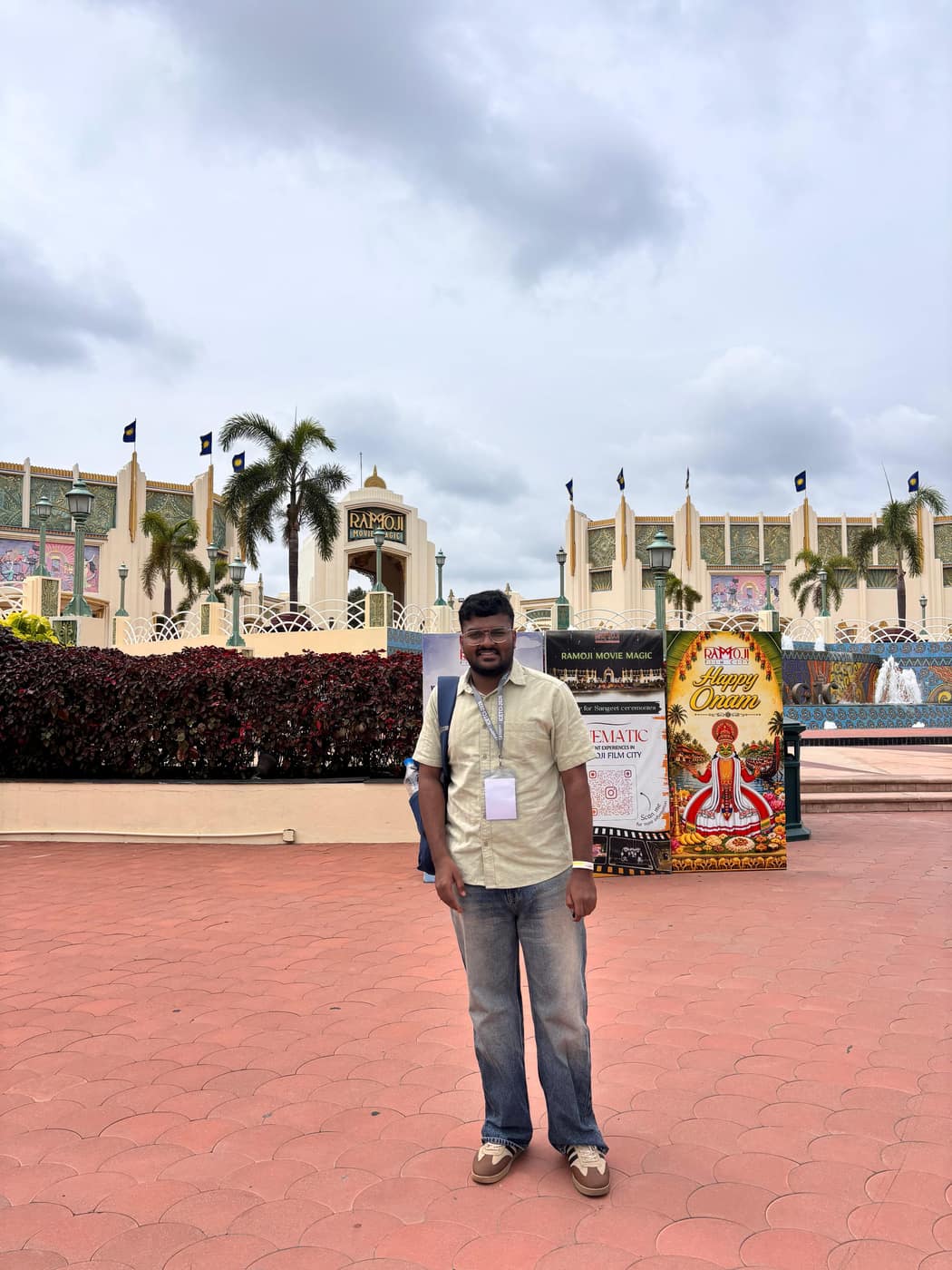 Aman Chandra H at a conference venue, wearing a delegate badge